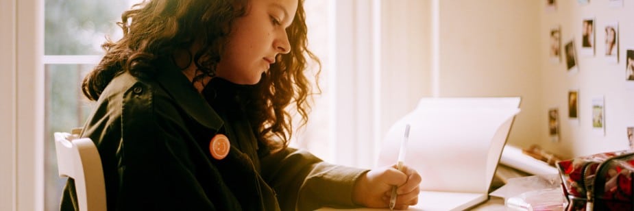 estudante escrevendo sobre as regras dos porquês